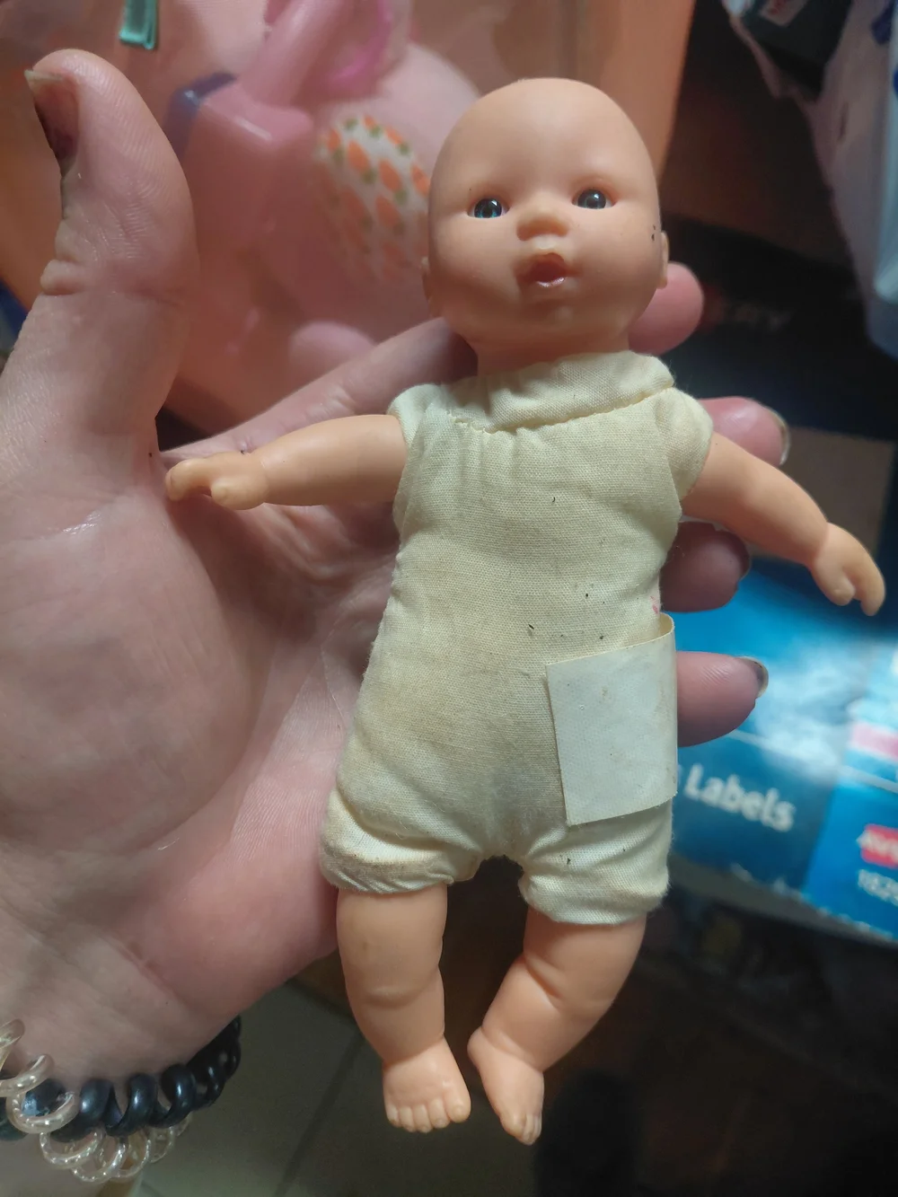 a vintage 1997 Corolle mini baby doll featuring blue eyes and a soft body.